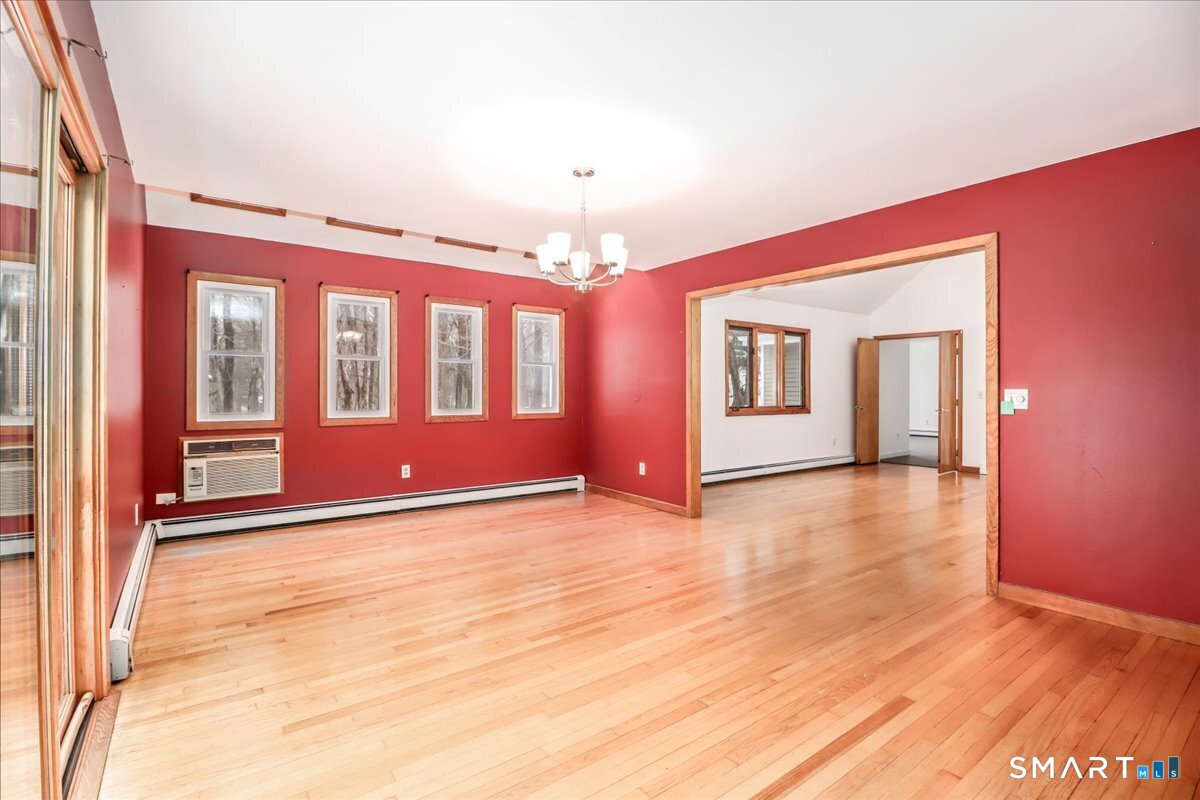 8 Pebble Lane New Milford, CT 06776 - Photo 16 of 44 a view of an empty room with window and wooden floor