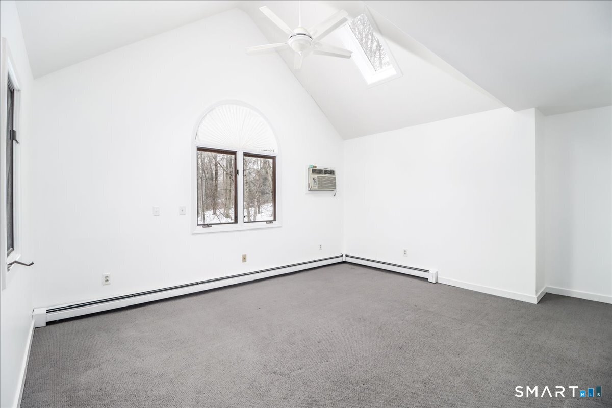 8 Pebble Lane New Milford, CT 06776 - Photo 17 of 44 an empty room with a windows and ceiling fan