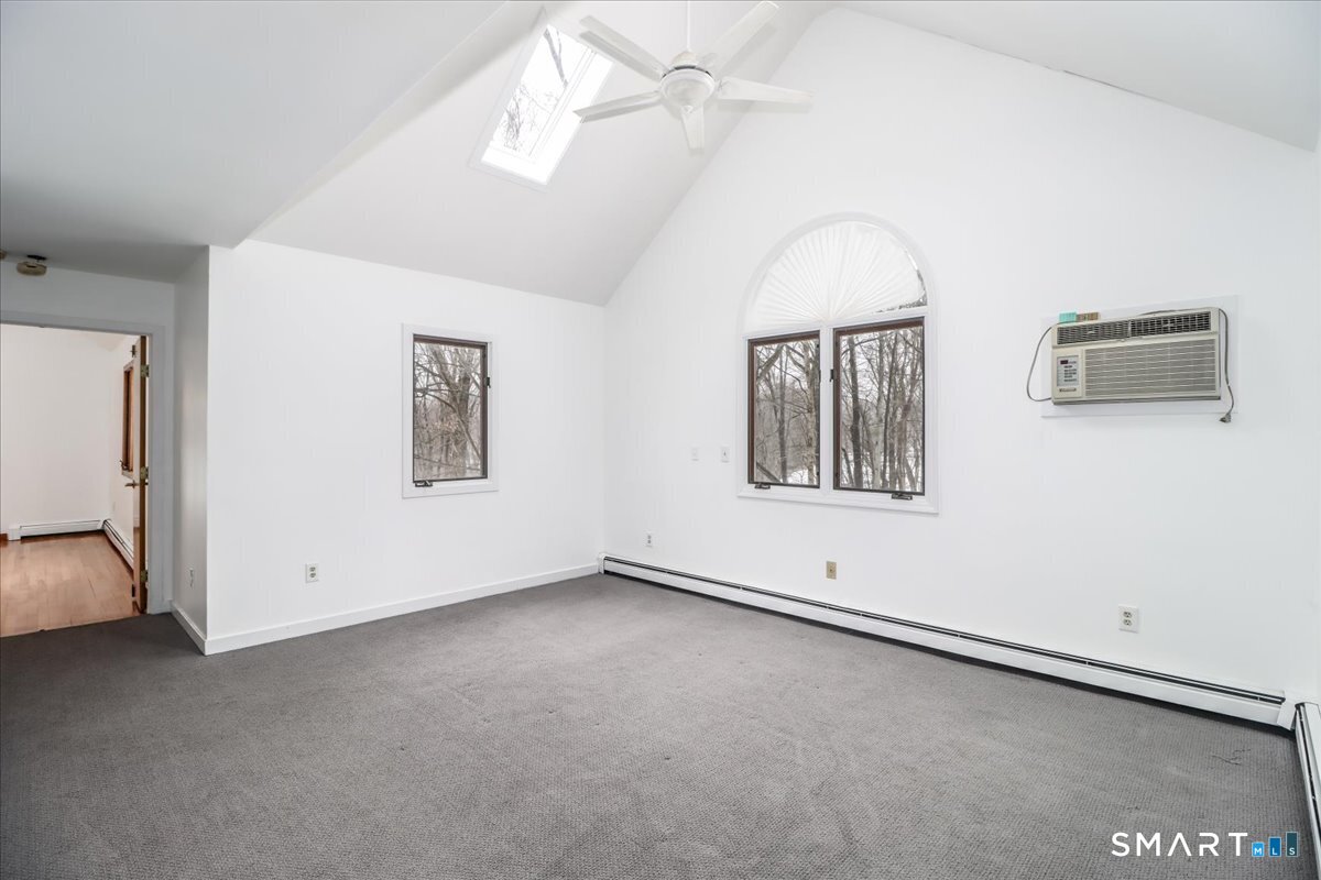 8 Pebble Lane New Milford, CT 06776 - Photo 18 of 44 an empty room with windows and fan