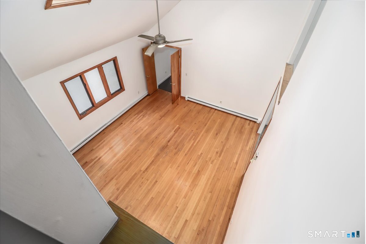 8 Pebble Lane New Milford, CT 06776 - Photo 22 of 44 a view of a hallway with wooden floor and staircase