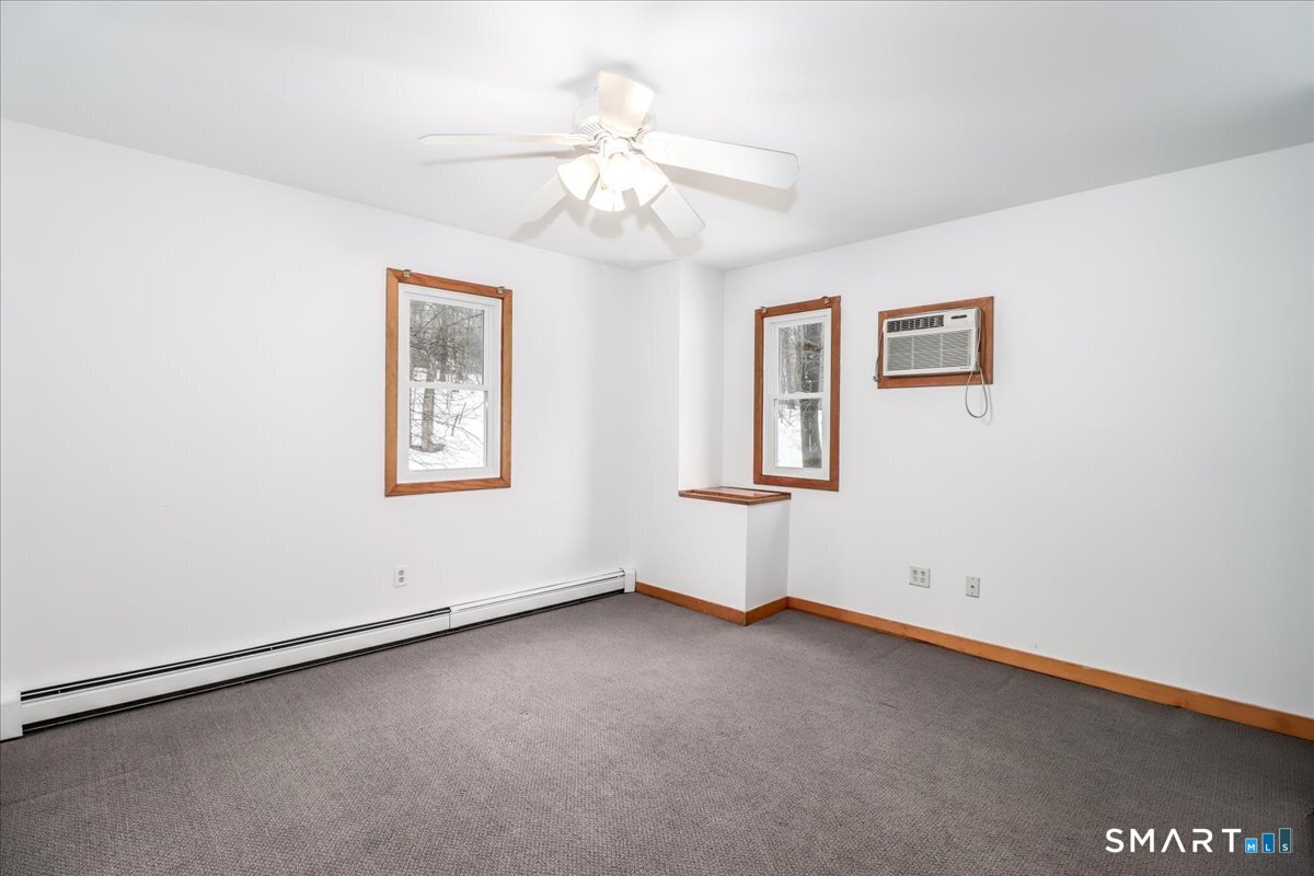8 Pebble Lane New Milford, CT 06776 - Photo 28 of 44 an empty room with windows and fan