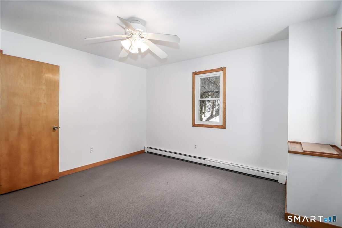 8 Pebble Lane New Milford, CT 06776 - Photo 29 of 44 an empty room with chandelier fan and windows