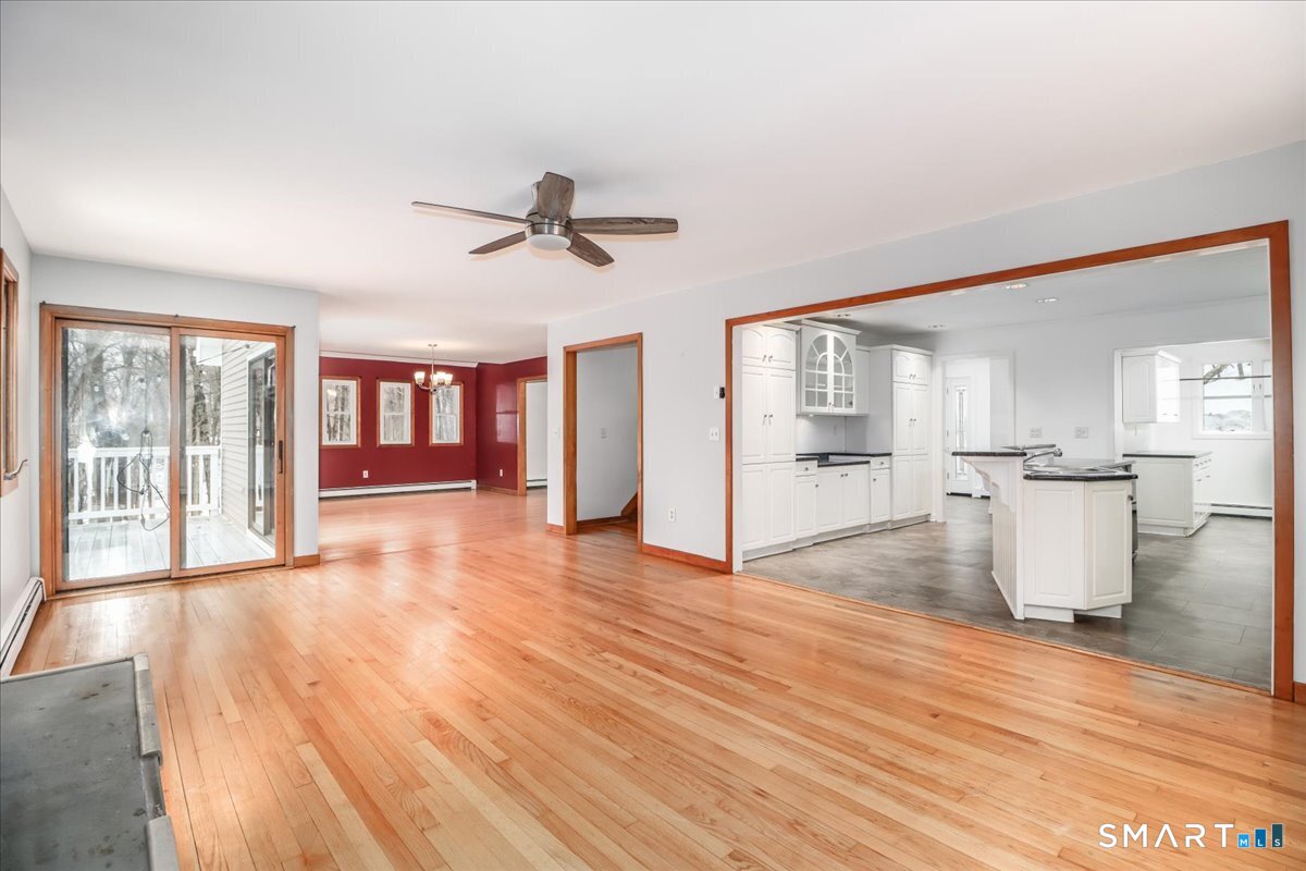 8 Pebble Lane New Milford, CT 06776 - Photo 7 of 44 a view of empty room with wooden floor and fan