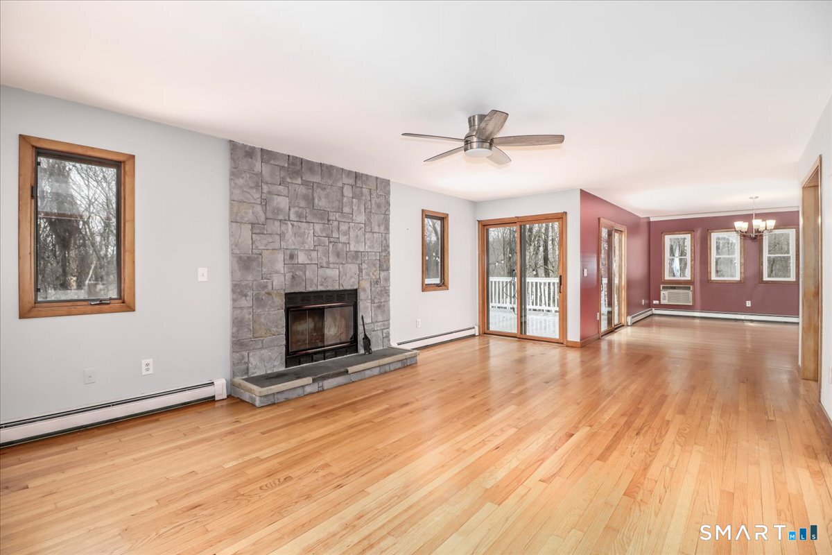 8 Pebble Lane New Milford, CT 06776 - Photo 8 of 44 a view of an empty room with wooden floor and a fireplace
