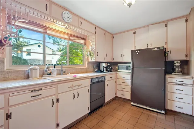 a kitchen with stainless steel appliances a sink stove and cabinets