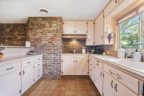 a spacious bathroom with a sink and a mirror