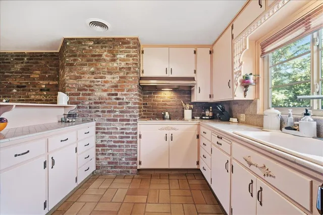 a spacious bathroom with a sink and a mirror