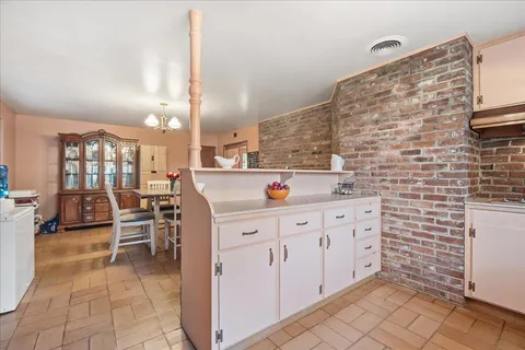 a bedroom with furniture and a large window
