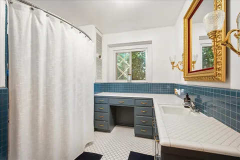 a bedroom with a bed and large window