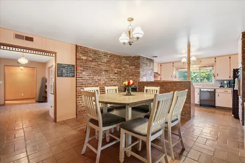 a view of a dining room with furniture window and outside view