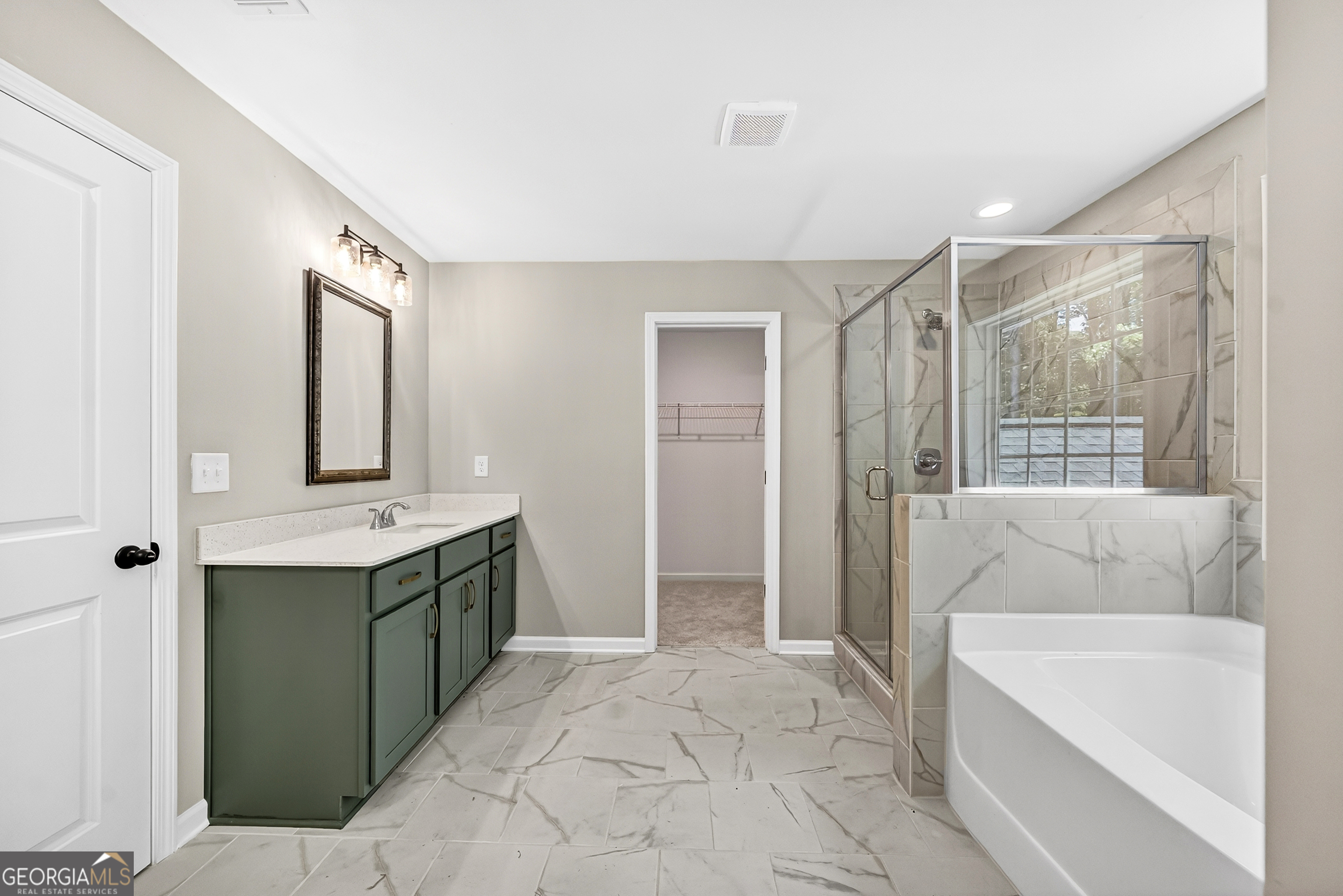 38 Oak Ridge Drive, Unit 26 Waverly Hall, GA 31831 - Photo 21 of 37 a bathroom with a tub sink and mirror