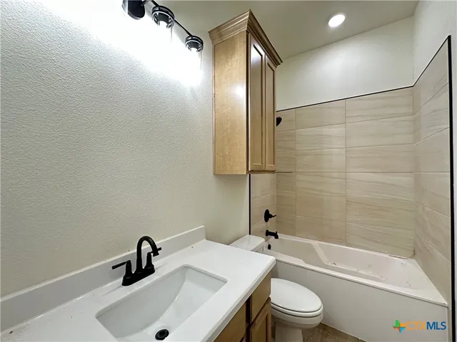 an empty room with closet and a chandelier fan