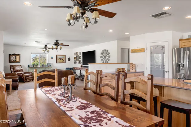 a living room with furniture a rug and white walls