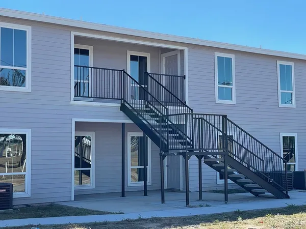 a view of a house with wooden stairs