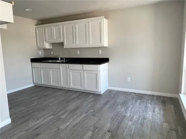 a kitchen with a sink a refrigerator and cabinets