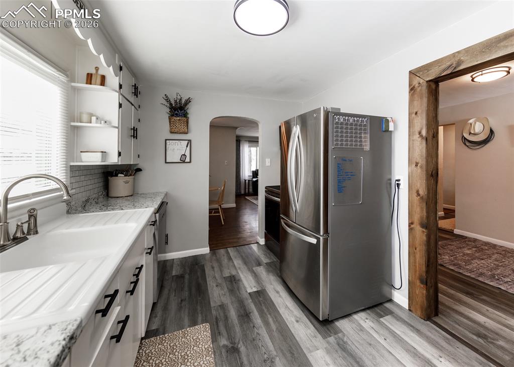 548 Denver Street Calhan, CO 80808 - Photo 13 of 40 a kitchen with stainless steel appliances a refrigerator a sink and wooden cabinets