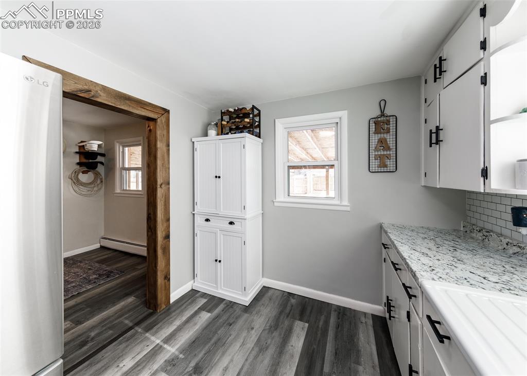 548 Denver Street Calhan, CO 80808 - Photo 15 of 40 a kitchen with granite countertop a sink and a stove top oven