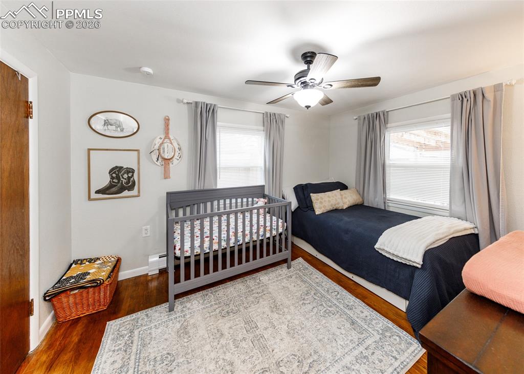 548 Denver Street Calhan, CO 80808 - Photo 18 of 40 a bedroom with a bed and a chandelier