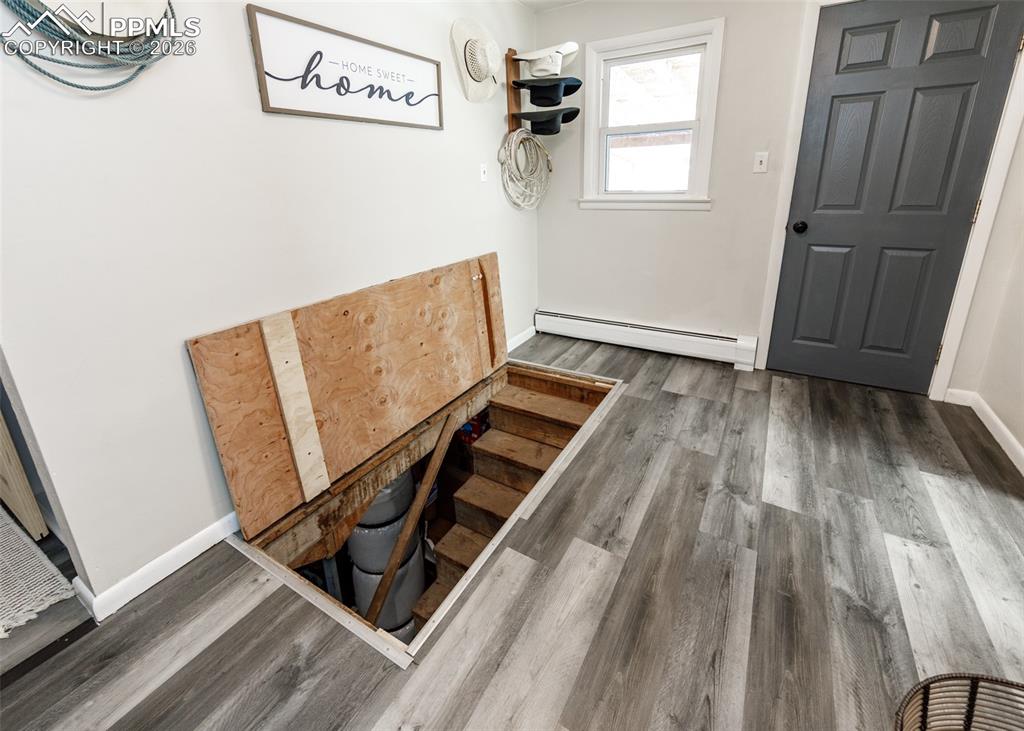 548 Denver Street Calhan, CO 80808 - Photo 29 of 40 a view of an empty room with wooden floor and a window