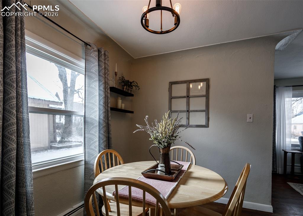 548 Denver Street Calhan, CO 80808 - Photo 9 of 40 a dining room with furniture a potted plant and a chandelier