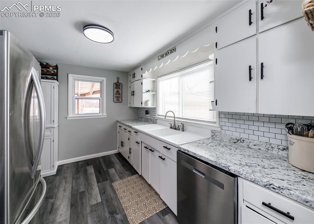 548 Denver Street Calhan, CO 80808 - Photo 10 of 40 a kitchen with a sink stove and refrigerator