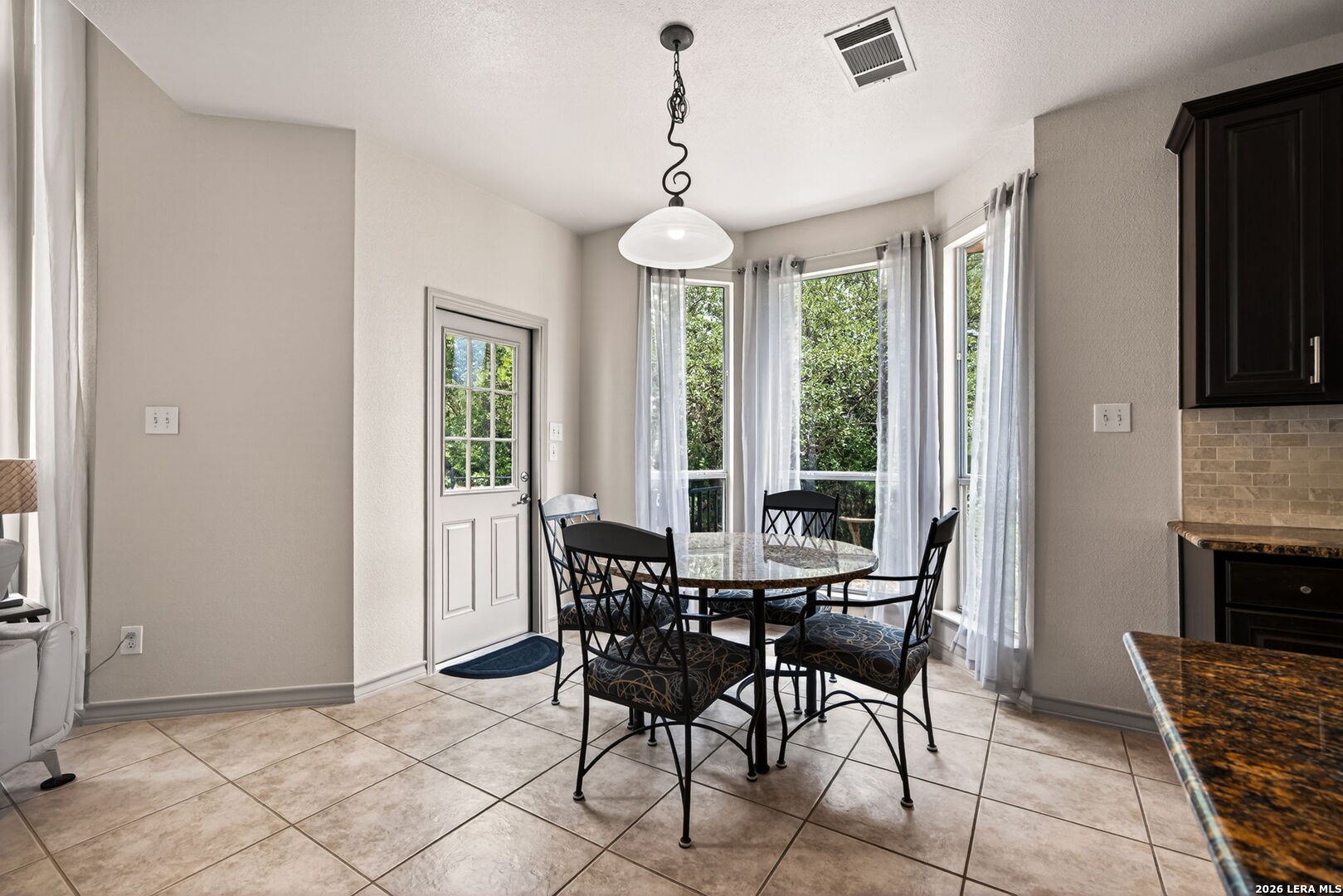 17431 Helotes Spring Road Helotes, TX 78023 - Photo 18 of 50 a view of a dining room with furniture window and outside view