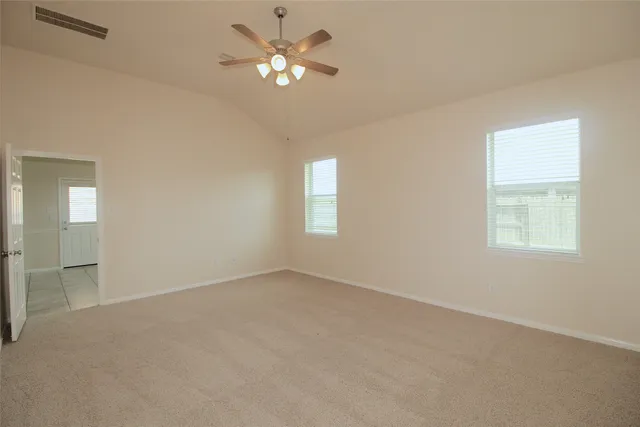 an empty room with a window and a bathroom