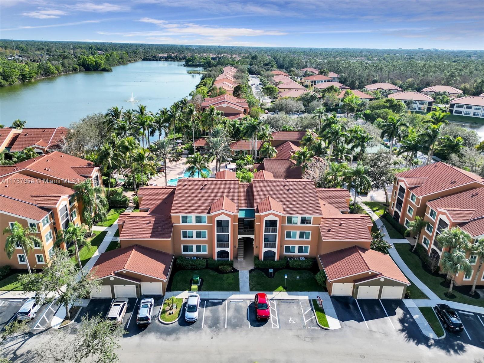 an aerial view of multiple houses with a lake view