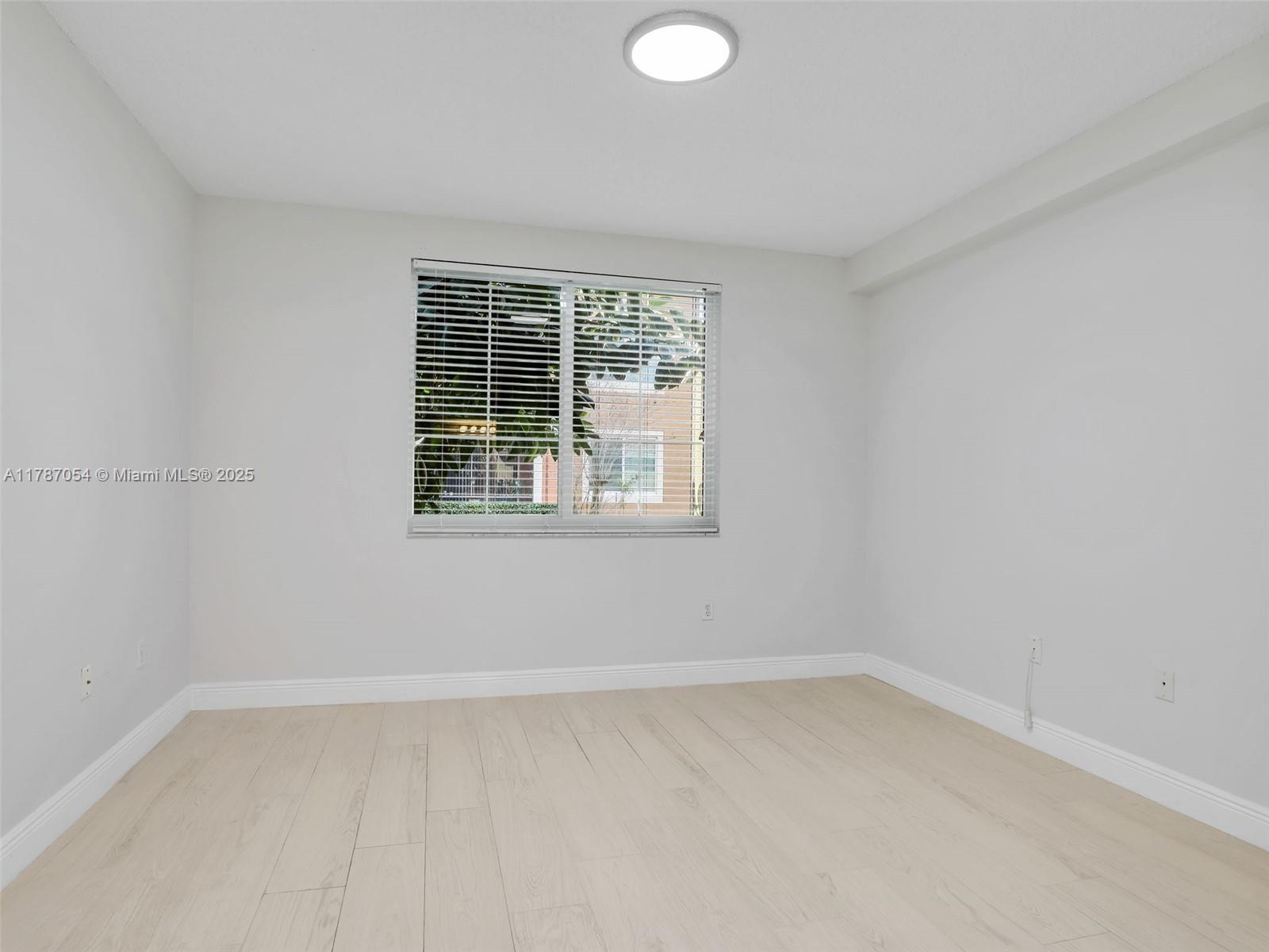 1235 Reserve Way, Unit 5107 Naples, FL 34105 - Photo 12 of 27 an empty room with a window
