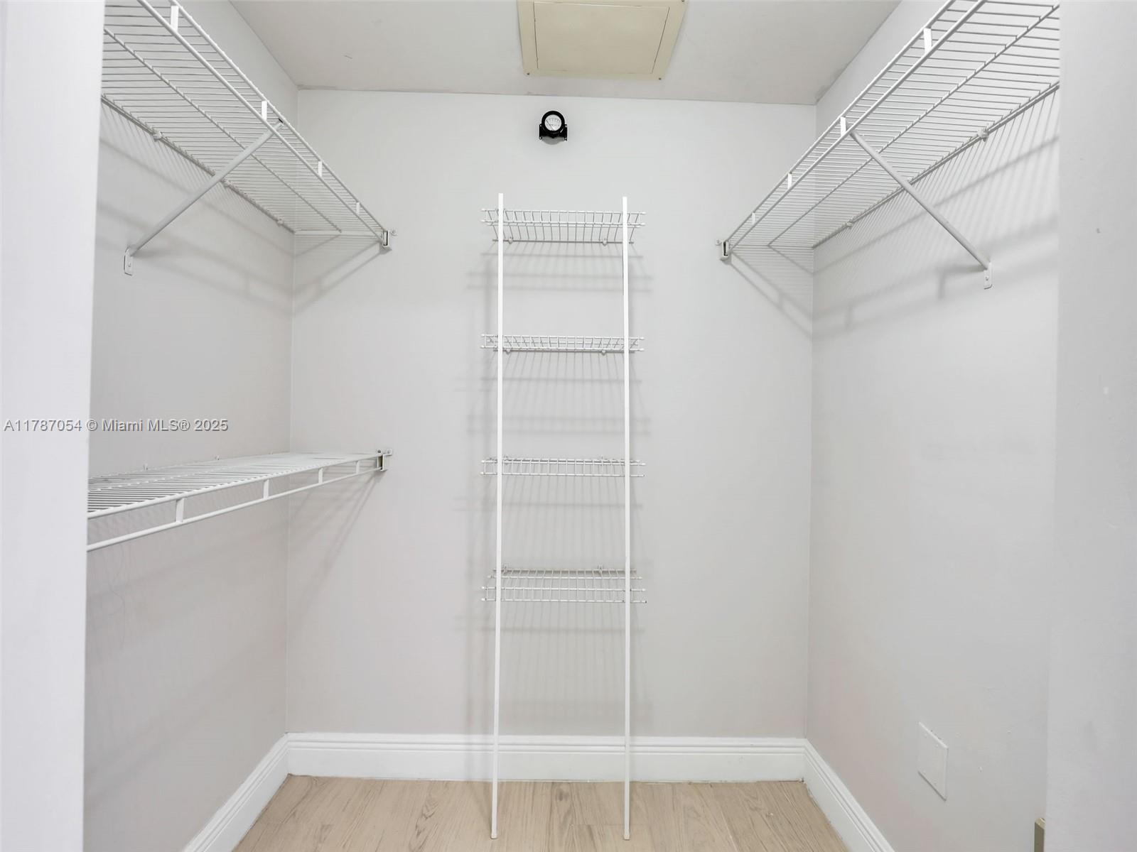 1235 Reserve Way, Unit 5107 Naples, FL 34105 - Photo 14 of 27 a view of walk in closet with empty racks