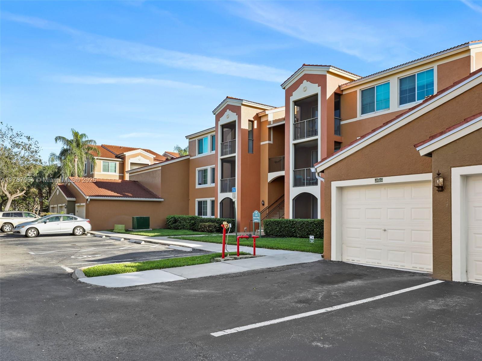 1235 Reserve Way, Unit 5107 Naples, FL 34105 - Photo 19 of 27 a front view of building with yard