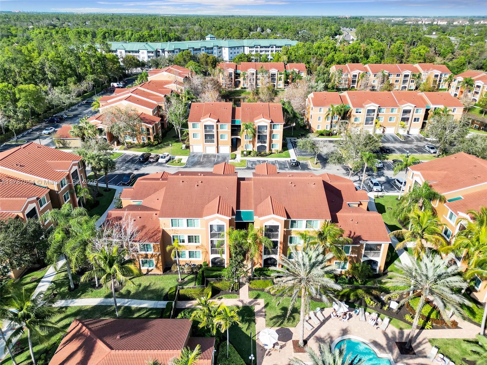 1235 Reserve Way, Unit 5107 Naples, FL 34105 - Photo 21 of 27 an aerial view of residential houses with outdoor space and trees all around