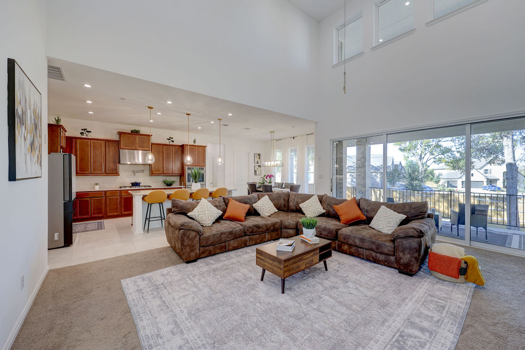 351 Pigeon River Road Kyle, TX 78640 - Photo 12 of 40 Living room featuring light carpet, recessed lighting, a high ceiling, and light tile patterned floors