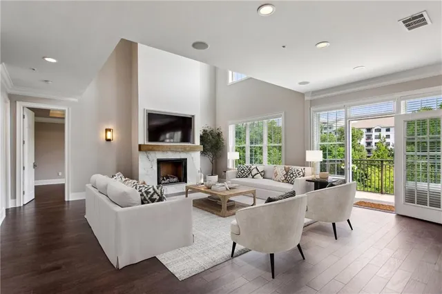 a living room with fireplace furniture and a large window