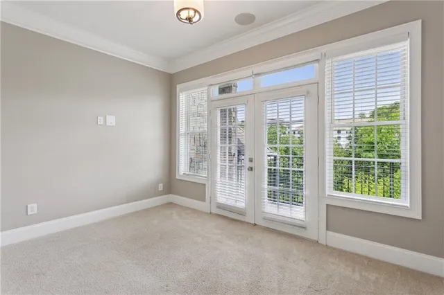 a view of buildings with yard and trees in the background