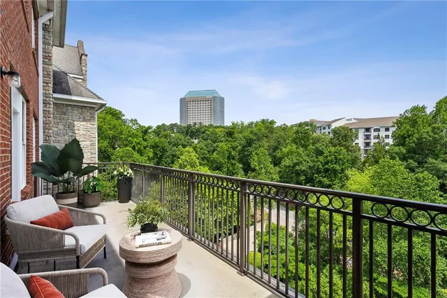 a large kitchen with stainless steel appliances kitchen island granite countertop a stove and a refrigerator
