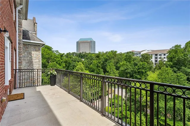 a view of a living room and kitchen with furniture wooden floor and a large window