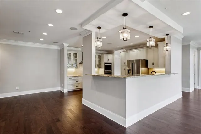 a kitchen with granite countertop a sink stainless steel appliances and window