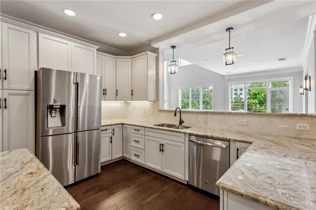 a kitchen with a stove sink and cabinets