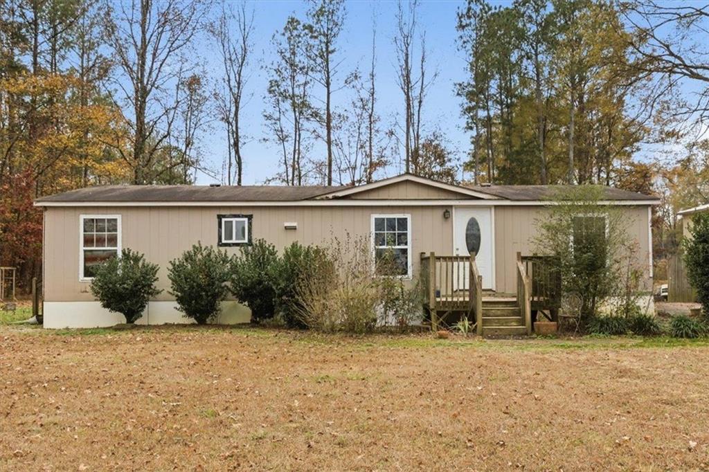 50 Jones Street Northwest Cartersville, GA 30120 - Photo 1 of 1 front view of a house with a bench in patio