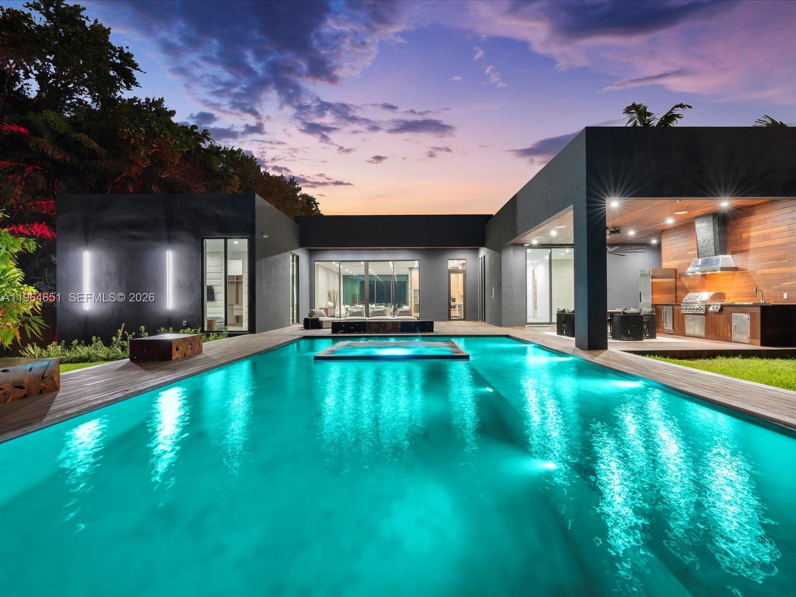 871 Northeast 83rd Street Miami, FL 33138 - Photo 1 of 54 a view of a swimming pool with an outdoor space and seating area