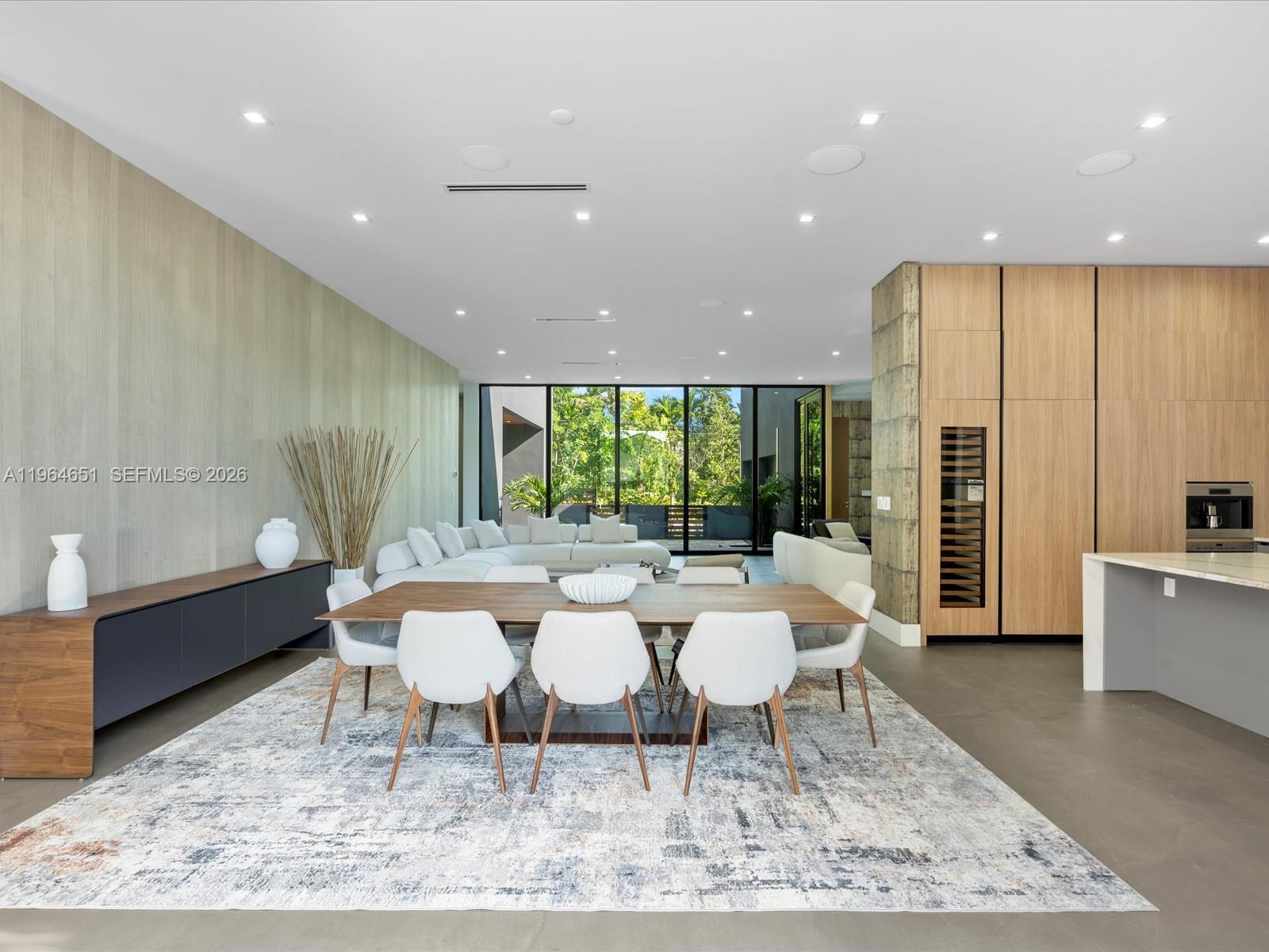 871 Northeast 83rd Street Miami, FL 33138 - Photo 16 of 54 a large dining space with furniture window and wooden floor