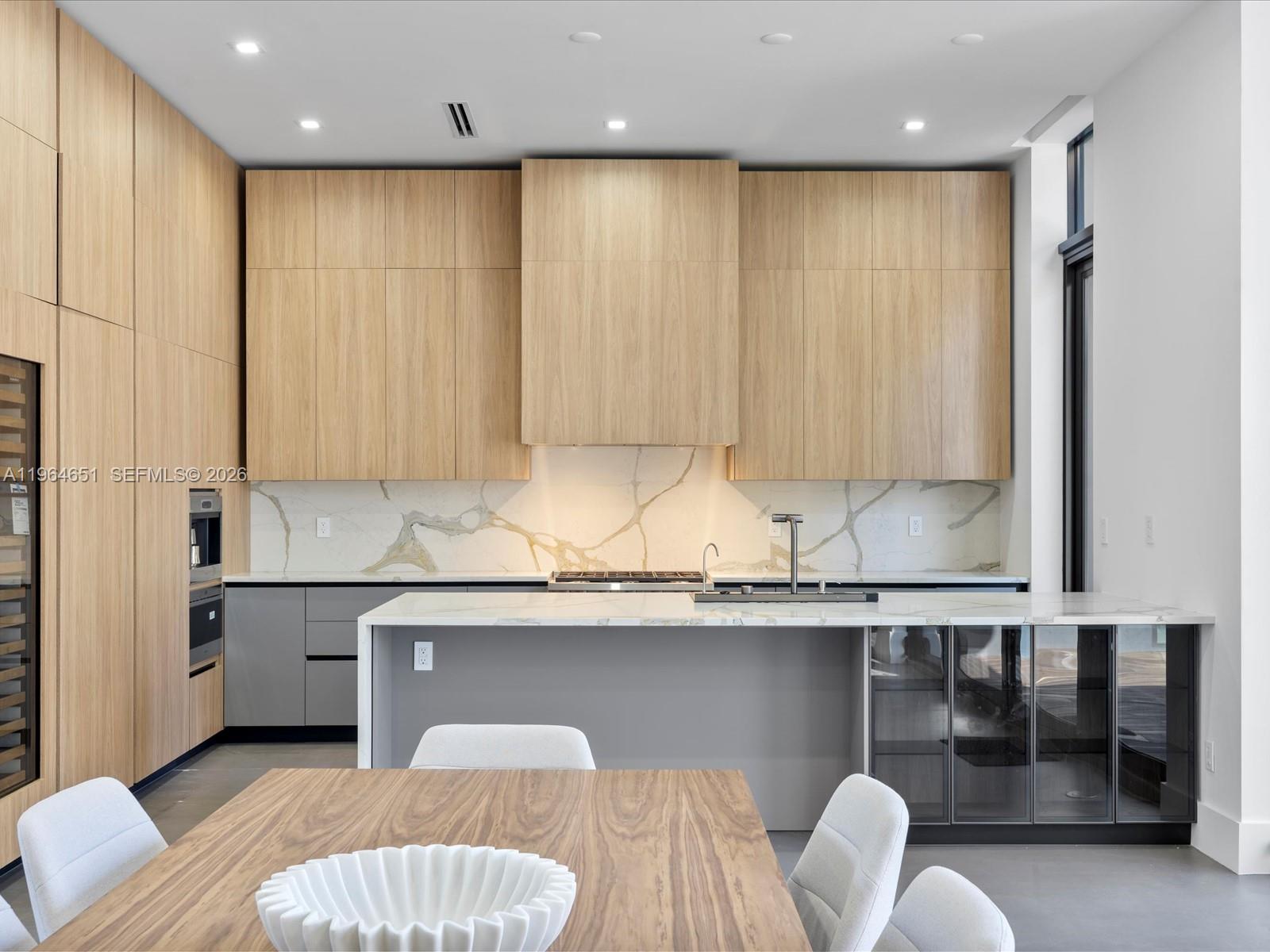 871 Northeast 83rd Street Miami, FL 33138 - Photo 31 of 54 a kitchen with a table and chair