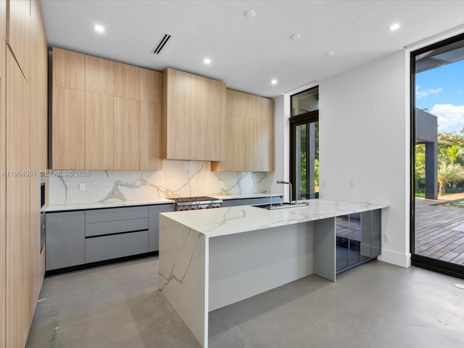 871 Northeast 83rd Street Miami, FL 33138 - Photo 33 of 54 a kitchen with stainless steel appliances granite countertop a stove and a sink