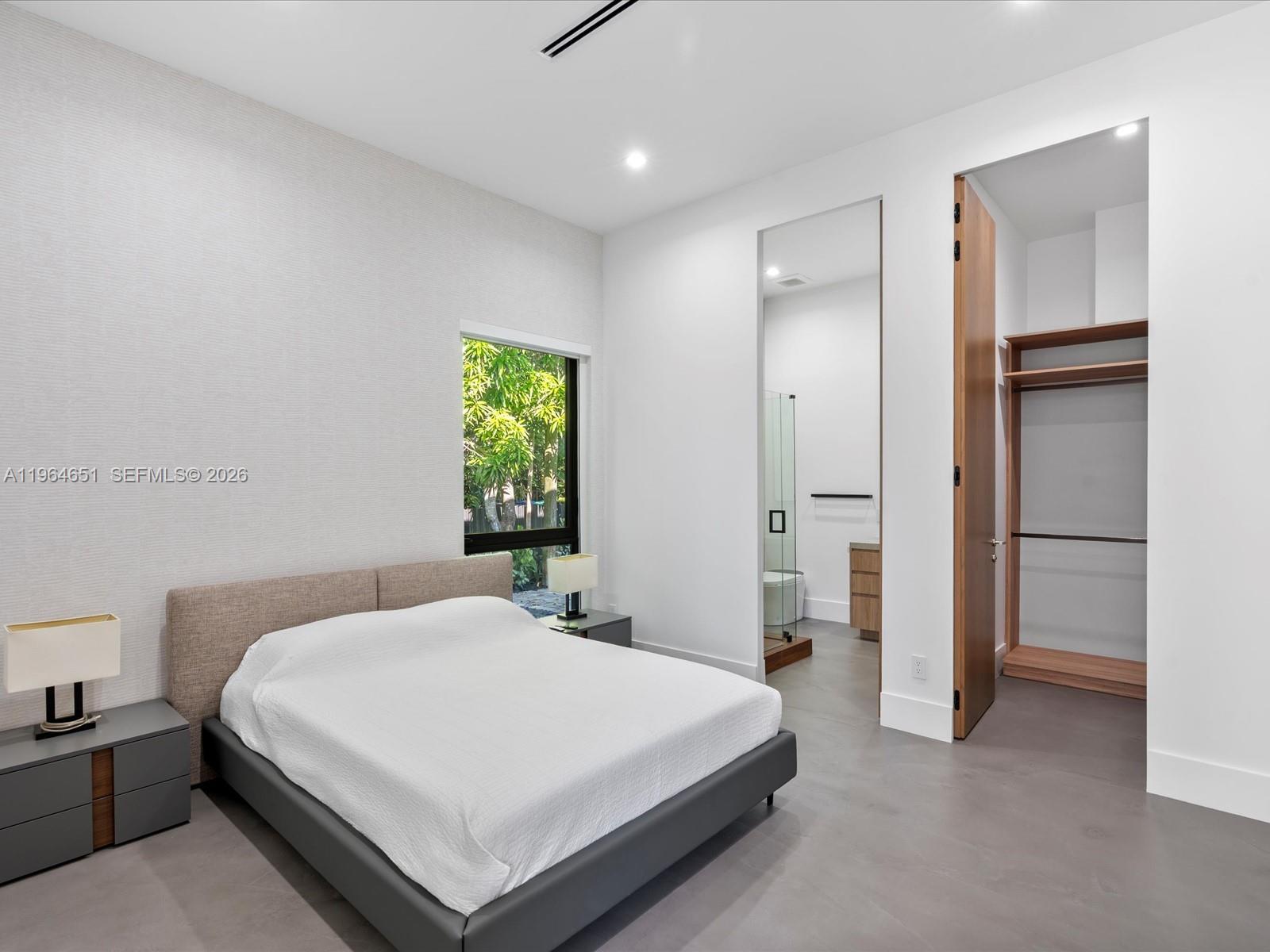 871 Northeast 83rd Street Miami, FL 33138 - Photo 38 of 54 a bedroom with a bed and a window