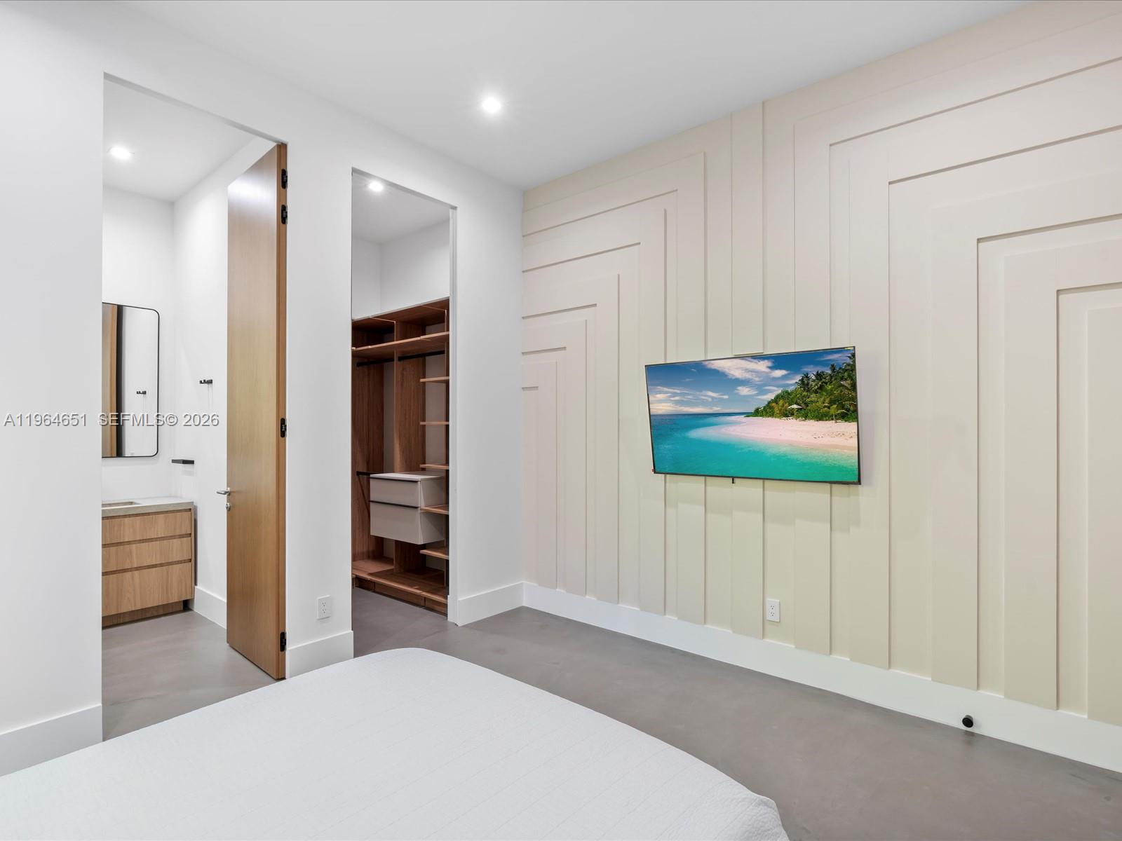 871 Northeast 83rd Street Miami, FL 33138 - Photo 39 of 54 a bedroom with a bed and a view of bathroom