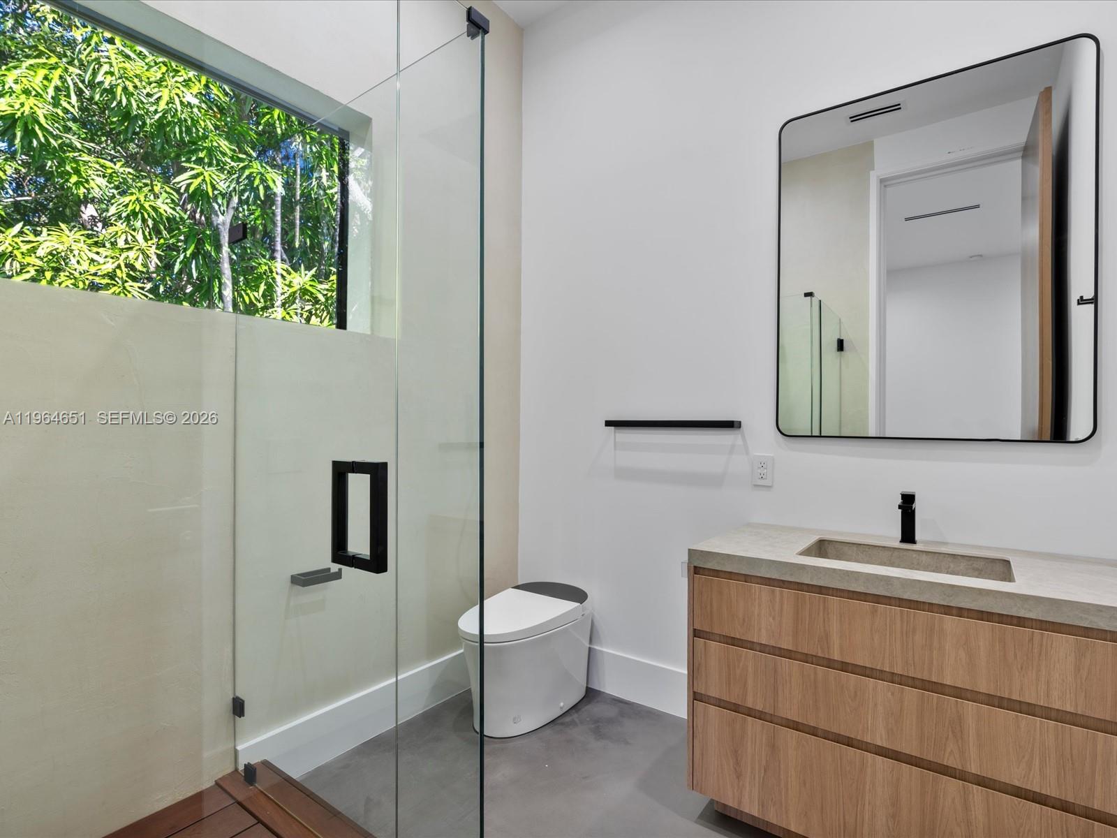 871 Northeast 83rd Street Miami, FL 33138 - Photo 41 of 54 a bathroom with a toilet sink and mirror