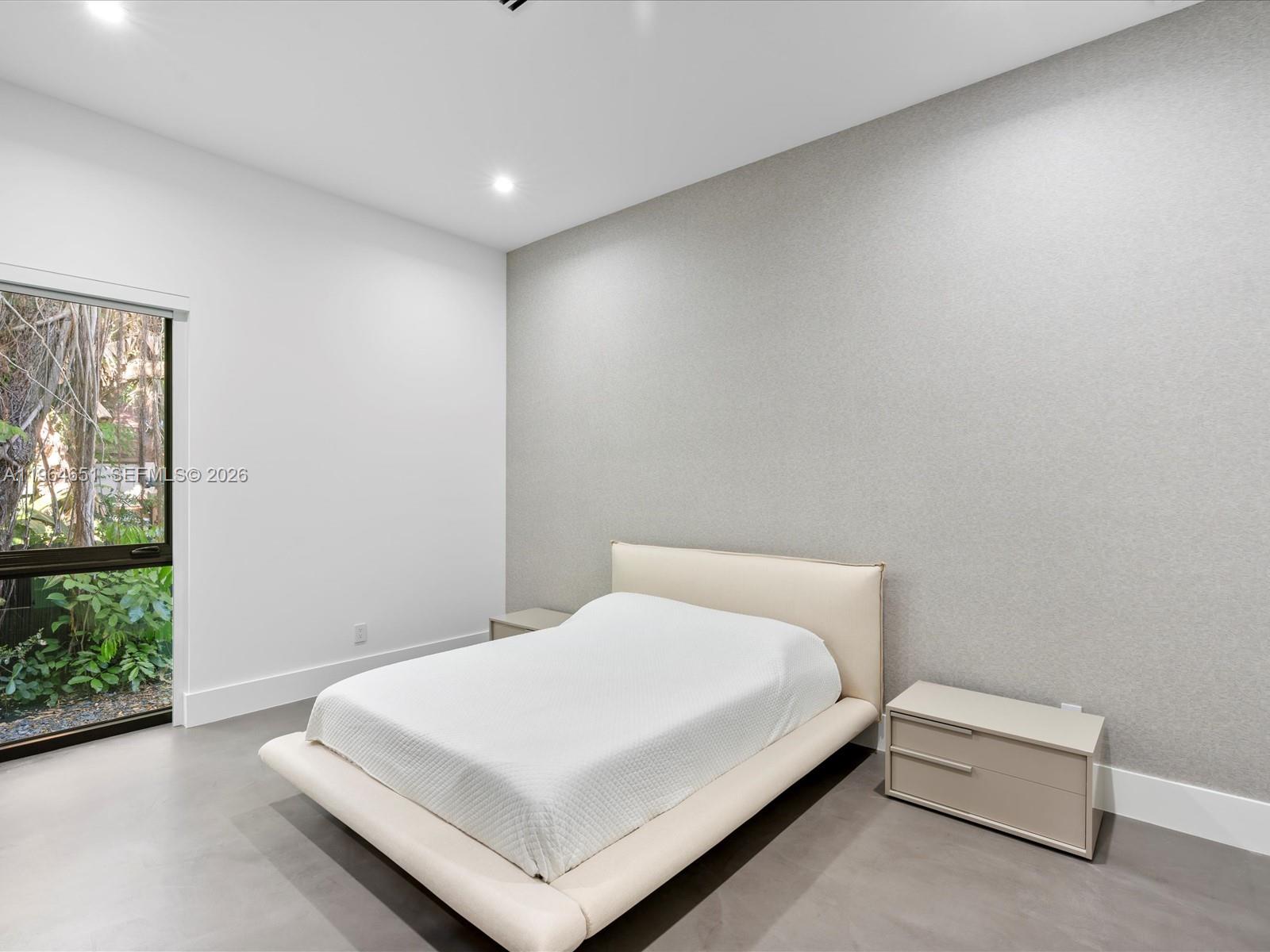 871 Northeast 83rd Street Miami, FL 33138 - Photo 42 of 54 a spacious bedroom with a bed and window