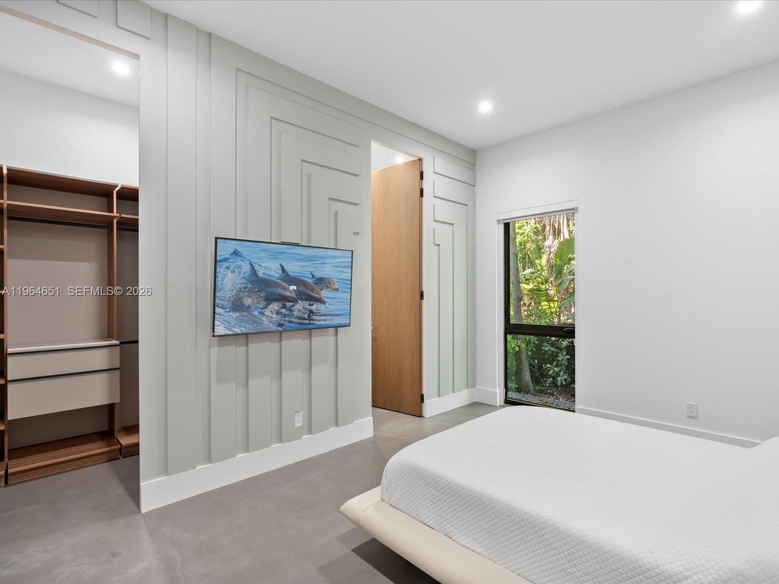 871 Northeast 83rd Street Miami, FL 33138 - Photo 43 of 54 a bedroom with a bed and a window