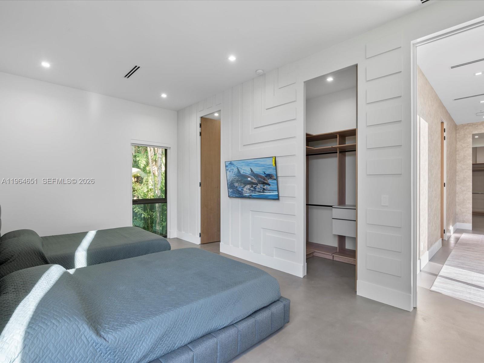 871 Northeast 83rd Street Miami, FL 33138 - Photo 47 of 54 a large bedroom with a bed and a refrigerator